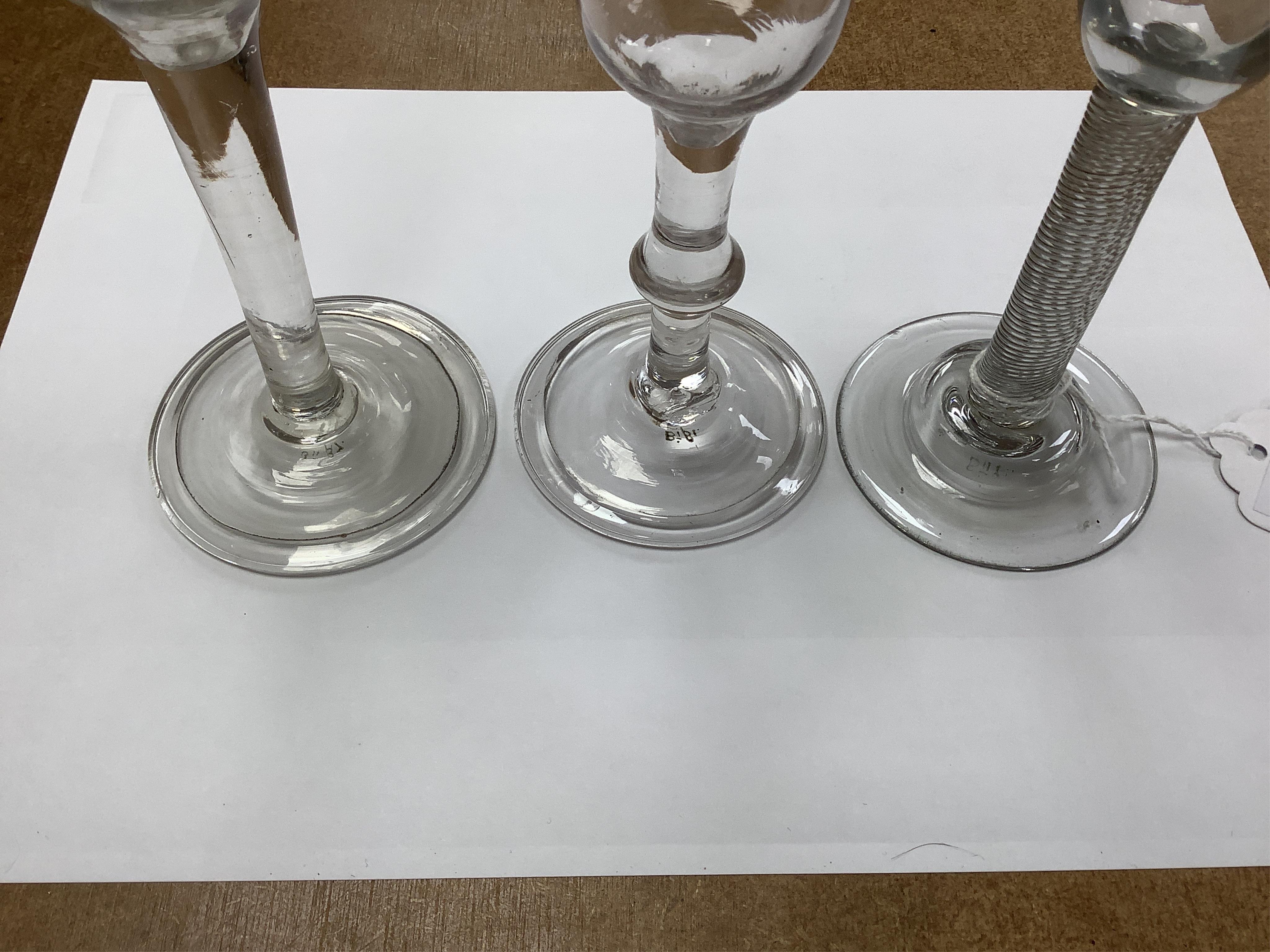 Three cordial glasses, first half 18th century, two with a folded foot, one with single knop and one with an incised twist stem, tallest 16cm